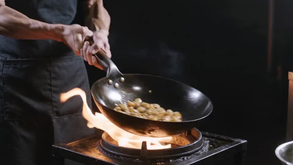 The wok goes over and the flame comes up through the food